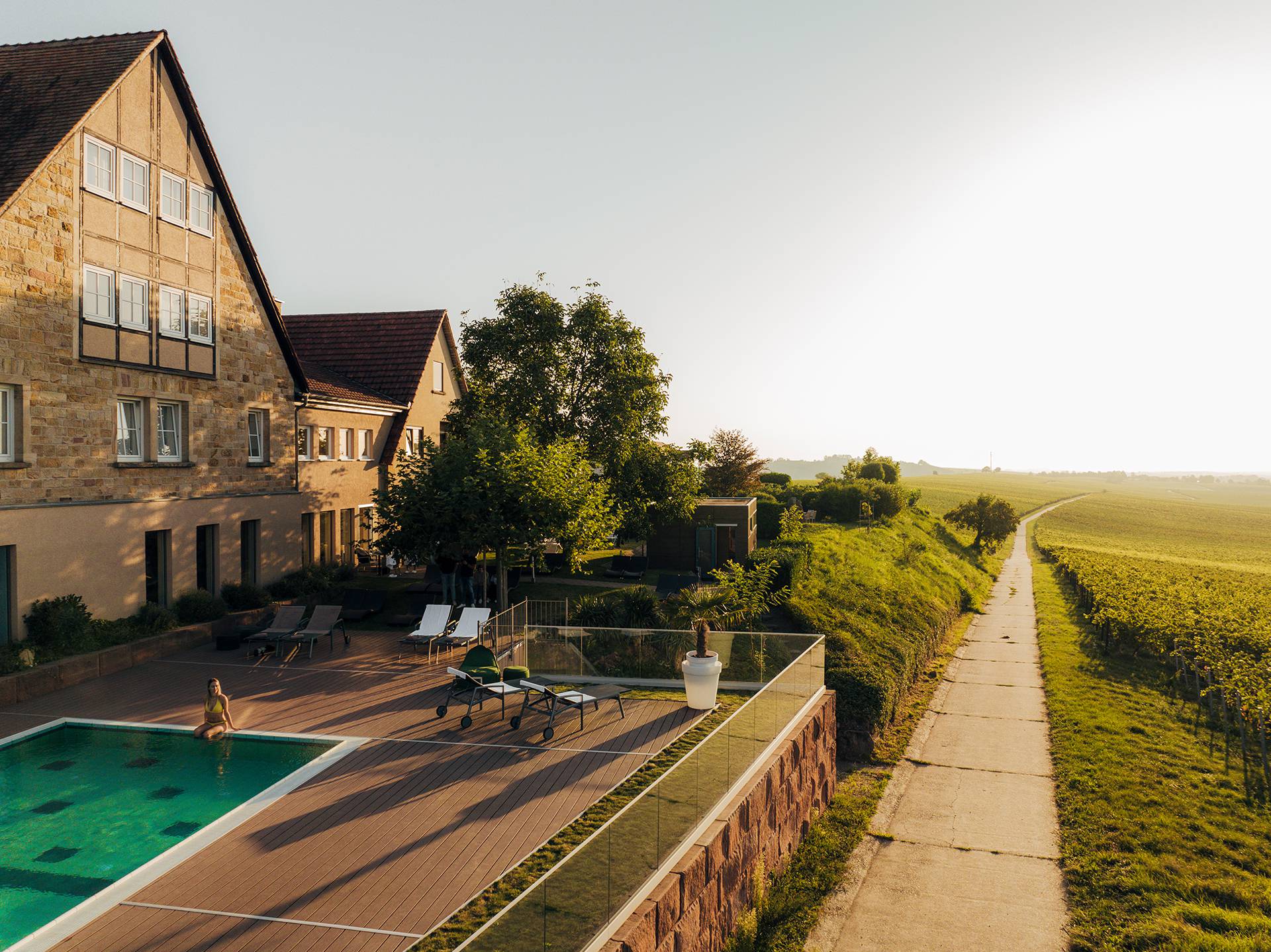 Leinsweiler Hof pool with a view of the vineyard